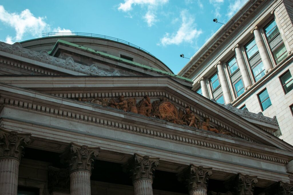 Imposing neoclassical building facade in Montreal, showcasing columns and architectural details.