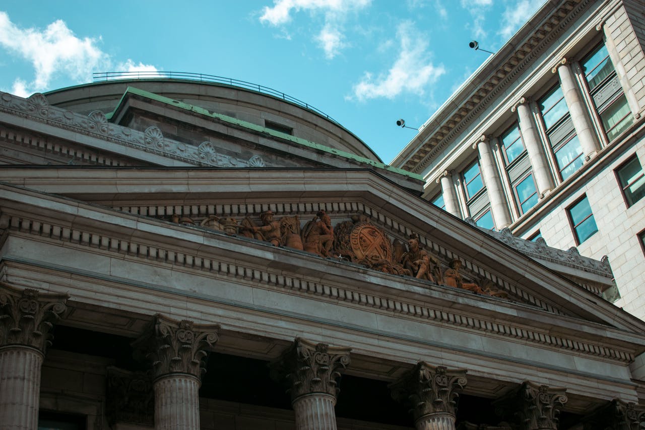 Imposing neoclassical building facade in Montreal, showcasing columns and architectural details.